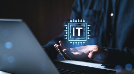 Fototapete - Information technology icon floating over open hand near laptop in dark room.