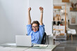 © insta_photos - Excited office worker winner using laptop computer celebrating goal achievement. Happy young woman student or employee winning online getting good news in email raising hands feeling euphoric.
