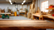 © Ula - Focused view of a wooden table in a busy workshop filled with tools and materials