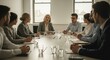 © fatkulmunif - Businesspeople seated around a conference table.