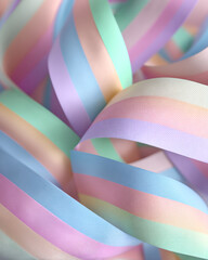 Poster - A close up view of pastel colored striped ribbons intertwined in a soft and flowing arrangement