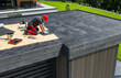 © Tomasz Zajda - Worker Installing EPDM Roofing Material on a Residential Flat Roof During a Sunny Day