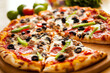 © pavlofox - Delicious pizza topped with pepperoni, olives, and green peppers