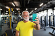 © pavlofox - Senior man enjoys taking a selfie at the gym during workout session