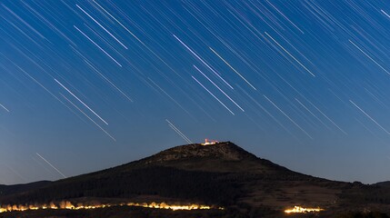 Wall Mural - Celestial trails over mountain at night