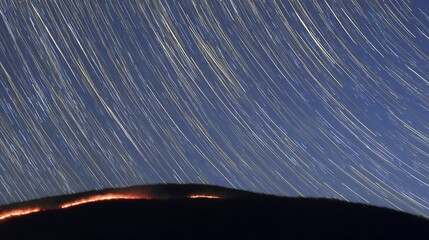 Wall Mural - Star trails above a burning ridge