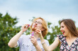 © Voyagerix - Couple blowing soap bubbles, having fun