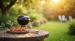 © JMour - Summer time in backyard with wooden table, grill BBQ and blurred background