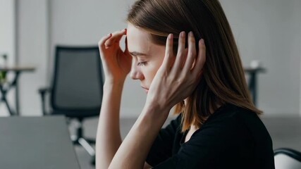 Poster - Young businesswoman suffering from a strong headache, massaging her temples and eyes, trying to relieve the pain and tension caused by stress and overwork in office