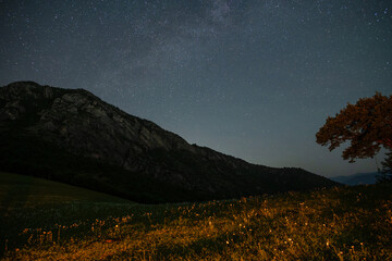 Wall Mural - beautiful night landscape, bright milky way galaxy over the mountains, starry sky.