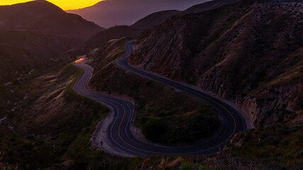 Wall Mural - night time lapse of traffic on a road winding through the mountains near los angeles.