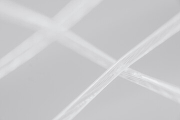 Macro, detailed, close-up shot of a tennis racquet's strings in black and white. Sports Equipment. Ball Sport and Game concept. Depth of field.