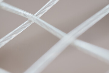 macro, detailed close-up shot of a tennis racquet's strings. sports equipment. ball sport and game c