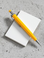 Poster - Yellow Mechanical Pencil Resting on White Card on Concrete, Symbolizing Creativity and Note Taking for Business Planning and Academic Success : Generative AI