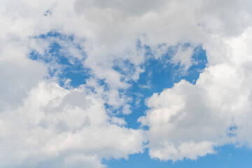 Wall Mural - Blue Sky with Fluffy White Clouds on a Sunny Summer Day. Cloudscape - Blue sky and white clouds. Background cloud summer. Sky cloud clear with sunset. Natural sky