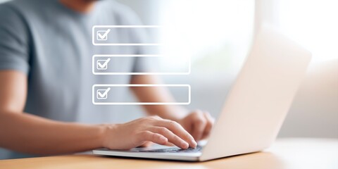 Fototapete - Individual using laptop at a wooden desk, engaged in online task management, with checkboxes displayed on screen, illustrating productivity and organization in a modern workspace