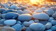 © Mlaku Banter - Closeup pebbles on beach at sunset