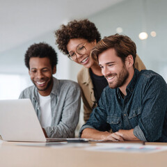 Poster - Enthusiastic colleagues collaborate, looking at a laptop screen. A diverse team thrives on shared success, idea generation, and positive company culture. Workplace harmony.