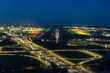 © Thomas - Night aerial view of illuminated airport runway and city lights
