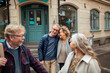 © Marko Geber - Happy senior friends exploring the city streets together on vacation