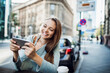 © Geber86 - Young woman using a smart phone in the city