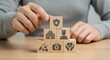 © Anwar Fauzan - Health insurance and medical care concept. Woman placing wooden blocks with health-related icons, medical care, health insurance, and medication. healthcare services, protection, insurance coverage,