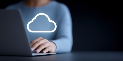Fototapete - Person using laptop with cloud icon displayed on screen, representing digital storage and online services, emphasizing technology and modern connectivity in a dark environment