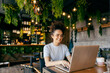 © Dusan Petkovic - Portrait of smiling interracial female freelancer working on freelance project and looking at the laptop.
