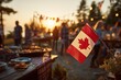 © Kristina - BBQ celebration at sunset with Canadian flag and happy people enjoying Canada Day outdoors with festive decorations and delicious food