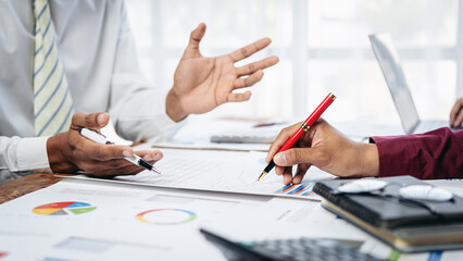 Fototapete - Two men are sitting at a table with a red pen and a white shirt
