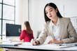 © Freedomz - A woman in a business suit is writing on a piece of paper