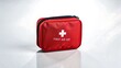 © millennium - Compact red first aid kit with white cross symbol on reflective surface and light background