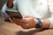 © Ambre - Detailed view of a man's hands actively typing on a smartphone. Represents mobile communication, instant messaging, and personal connectivity in the digital age.
