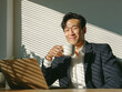 © 달지은 - Smiling Korean Businessman Enjoying Coffee / 커피를 마시며 미소 짓는 한국인 사업가