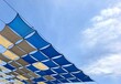 © Thanakrit - Blue and Beige Diamond Shaped Shade Sails Against Sky