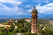 © Peter Stein - View of the Torre De Les Aigues De Dos Rius water tower on top of Tibidabo hill in amusement park in summer, with Mediterranean sea in background, Barcelona, Spain
