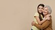 © Vyatcheslav - Young girl hugging elderly woman smiling on neutral background