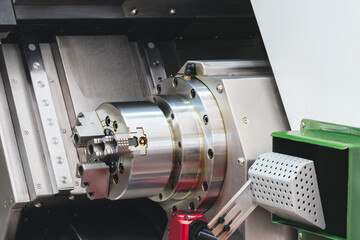 Aufkleber - machine with a large, shiny, silver part. The machine is in a workshop. The machine is used for cutting and shaping metal