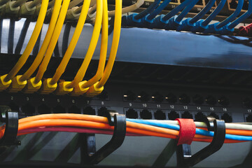 Poster - multi-colored fiber optic wires inserted into electronic switching unit, industrial internet communication concept background
