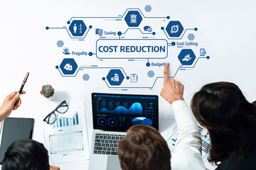 Aufkleber - This image depicts a collaborative office setting focusing on cost reduction strategies, highlighting budgeting and frugality alongside informative graphs and visuals. Amity