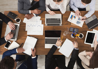 Leinwandbilder - Diverse business team at meeting, discussing marketing strategy and working on gadgets, top view