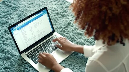 Poster - Person Typing on Laptop with Curly Hair in White Shirt on Blue Shag Rug