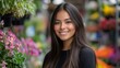 © ace - Smiling young woman with long dark hair, posing amidst colorful flowers in a vibrant setting