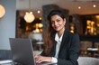 © Selvi - Woman working laptop indoors professional attire