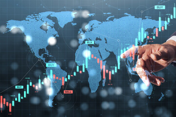 Aufkleber - Hand pointing at global stock market chart with buy and sell indicators over world map in digital finance concept background with blur effects.