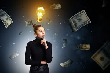 Poster - Thoughtful businesswoman with glowing lightbulb symbolizing idea, surrounded by floating money on abstract dark background with soft light.