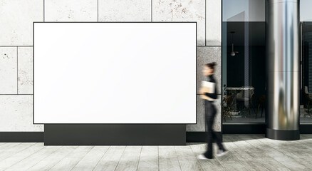Aufkleber - Blank white billboard mockup on modern building facade with blurred person walking by on tiled street in bright daylight outdoors.