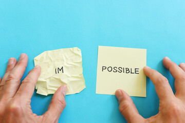 Poster - The word impossible is divided into two parts. success and challenge concept.