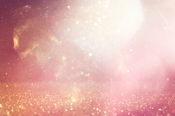 Wall Mural - abstract glitter pink and gold lights background. de-focused