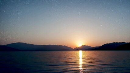 Wall Mural - a a movement of stars in the night sky with the view of mountains.